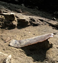 thin stone against dirt ground