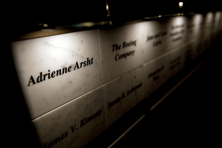 A tile on a wall indicates that Adrienne Arsht made a big donation