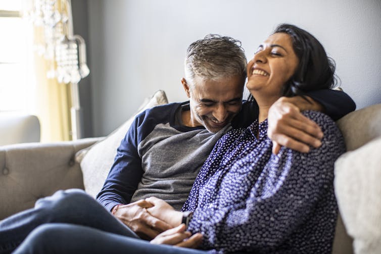 man and woman relaxing on couch