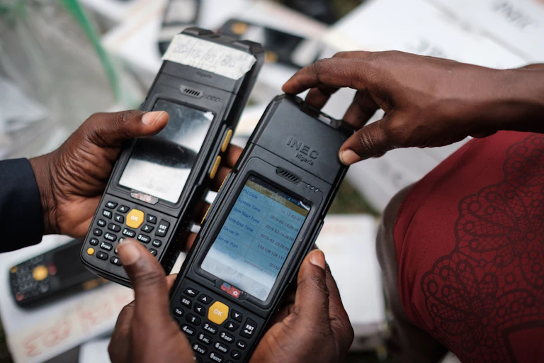 People holding electronic card readers