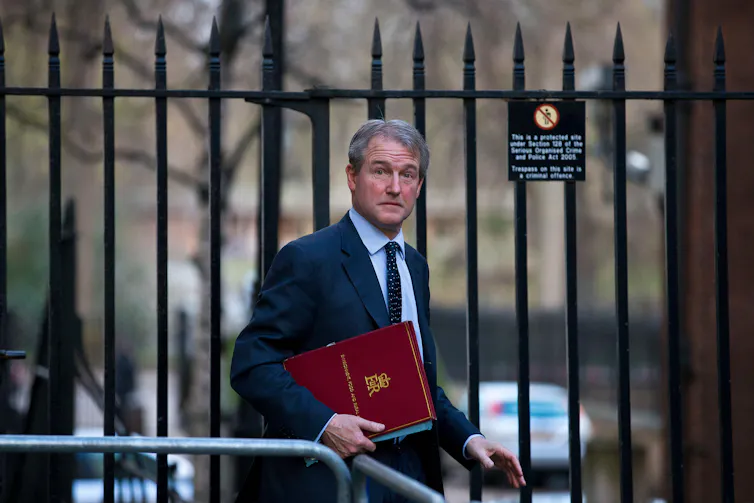 Former MP Owen Paterson walking in Westminster.