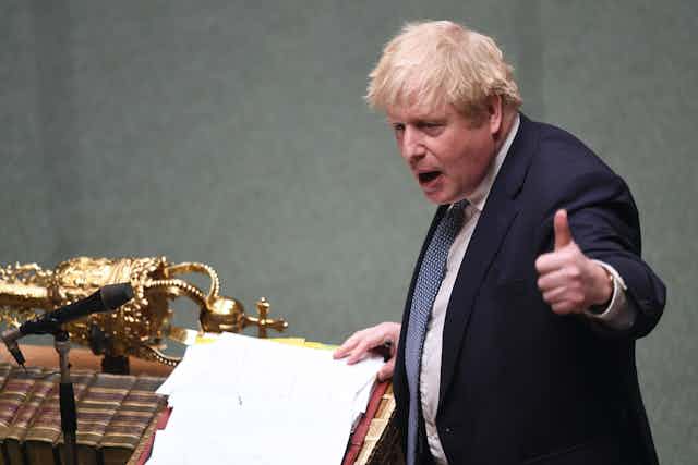 Boris Johnson giving a 'thumbs up' to the speaker while standing at the dispatch box in the House of Commons.