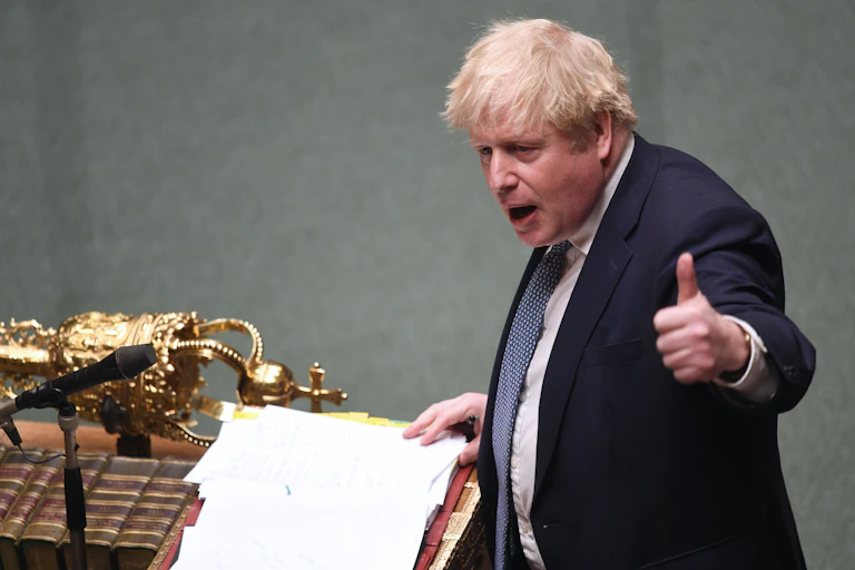 Boris Johnson giving a 'thumbs up' to the speaker while standing at the dispatch box in the House of Commons.