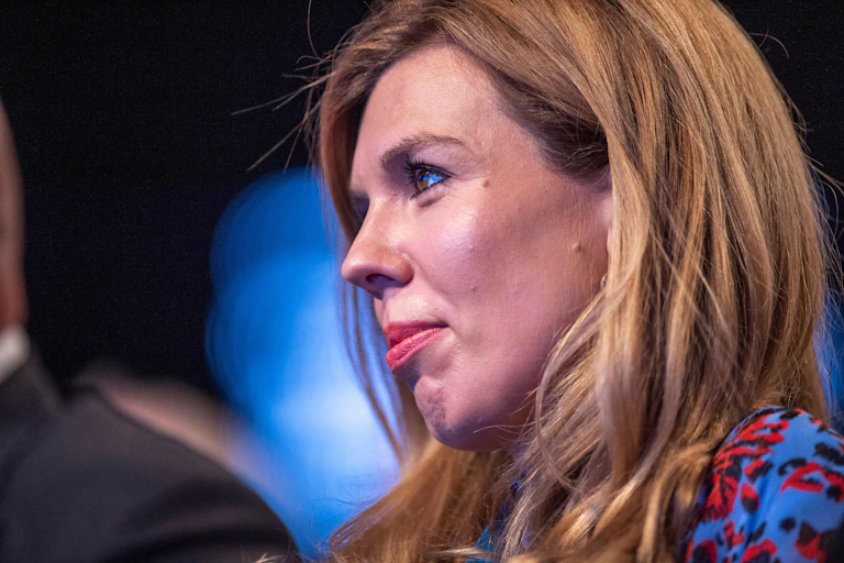 Carrie Johnson listening to a speech.