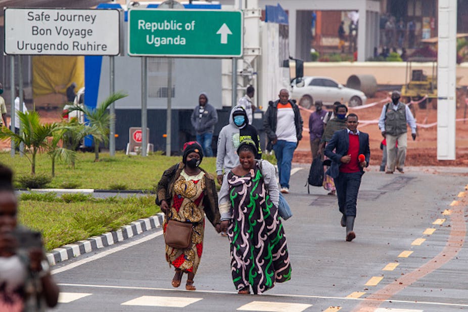people waiting to cross border between Rwanda and Uganda