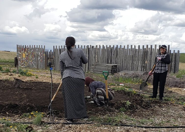 Woman stand working on a garden