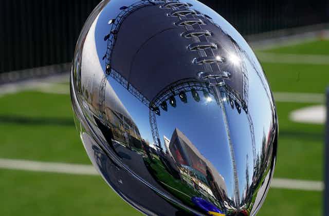 SoFi Stadium is reflected in the Vince Lombardi Trophy before NFL Commissioner Roger Goodell addresses the media at a news conference Wednesday, Feb. 9, 2022, in Inglewood, Calif.