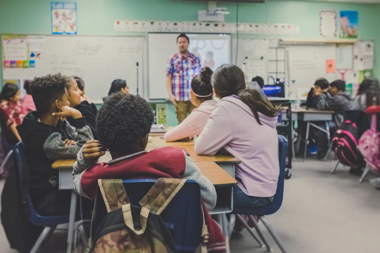 High school students look at their teacher.