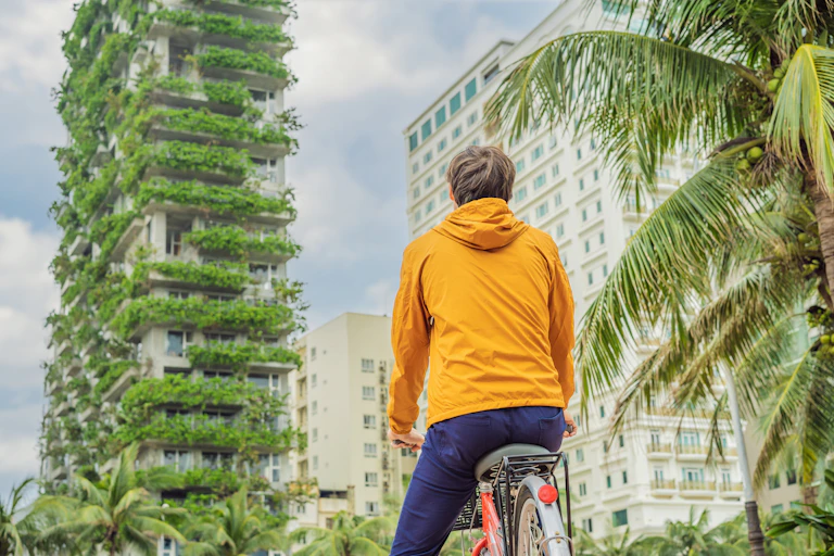 bike rider looks at green buikding