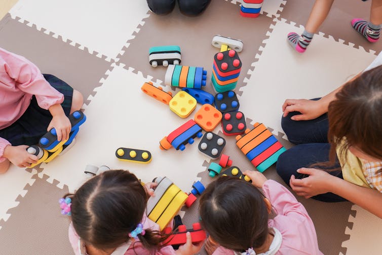 Children playing with blocks on floor