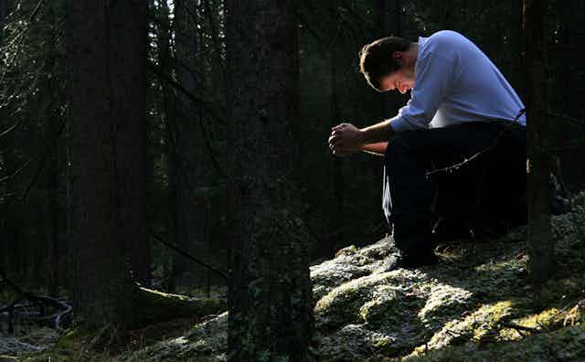 man in forest praying