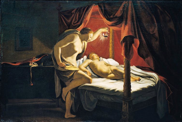 A painting showing a young woman holding a lamp to view a sleeping, naked Cupid.