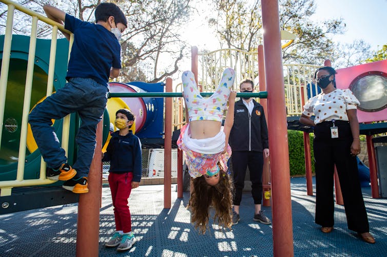 Children play on a playground structure