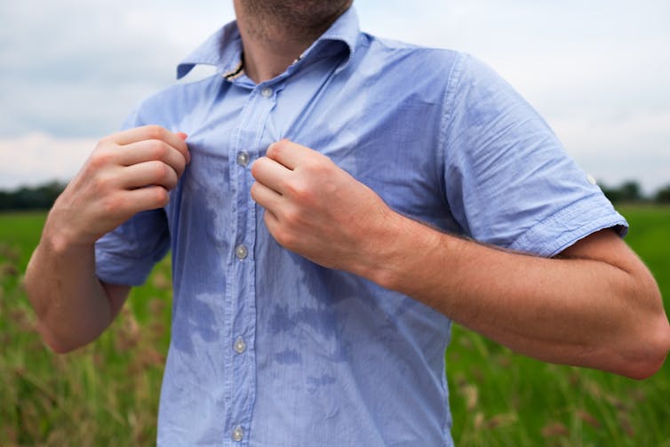 Man sweating in blue shirt