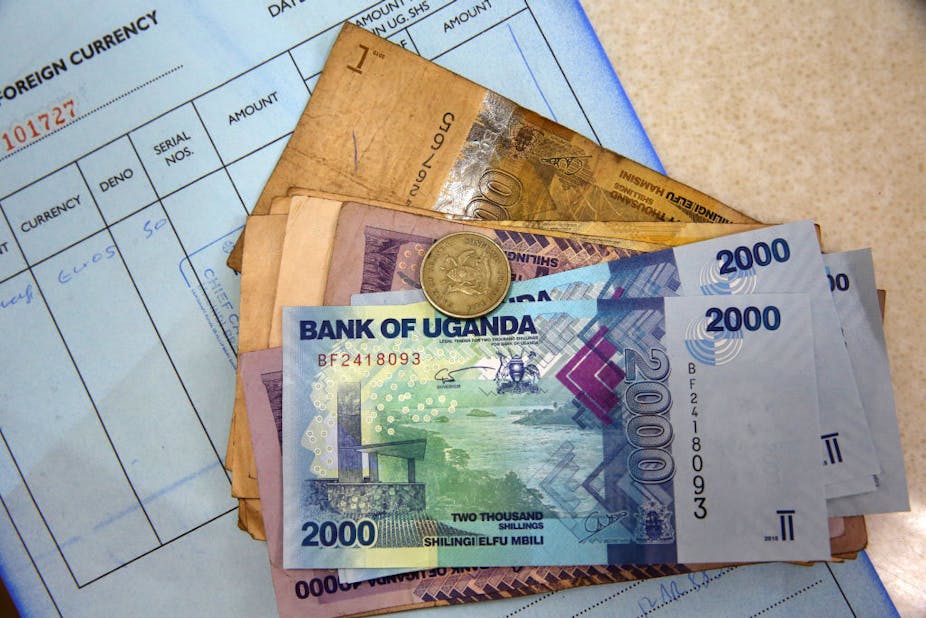Uganda shilling banknotes and a coin.
