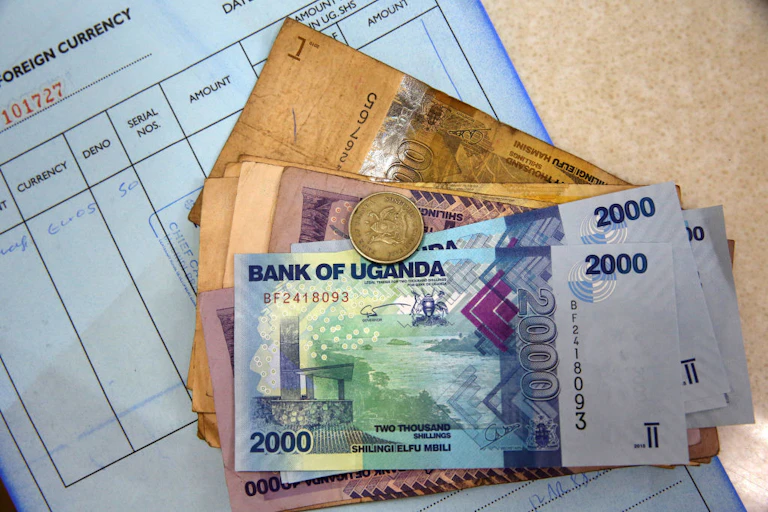 Uganda shilling banknotes and a coin.
