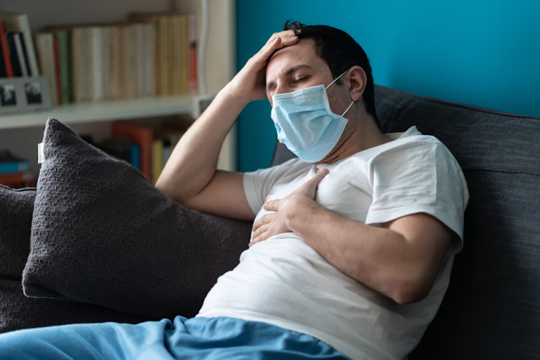 A man with COVID wearing a mask