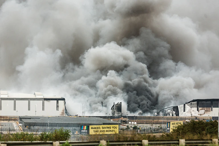 Smoke billows into the sky from a large building
