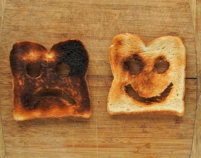 Burnt toast with a sad face and golden-brown toast with a smiley face