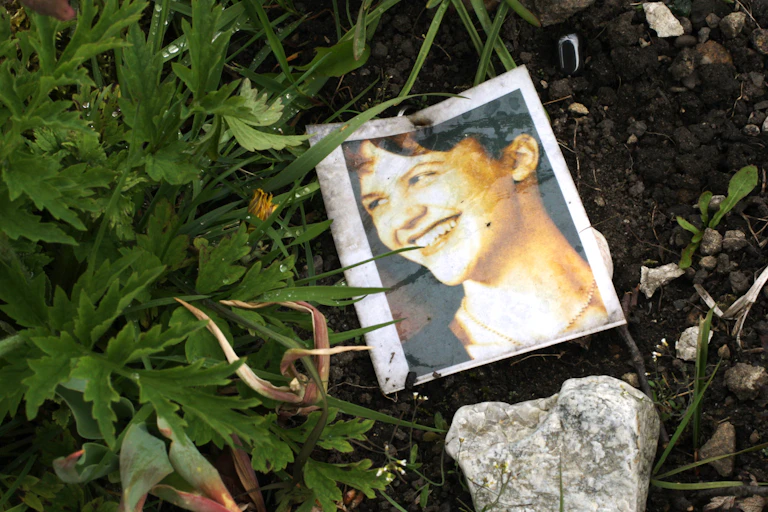 A photograph of a woman on the ground.