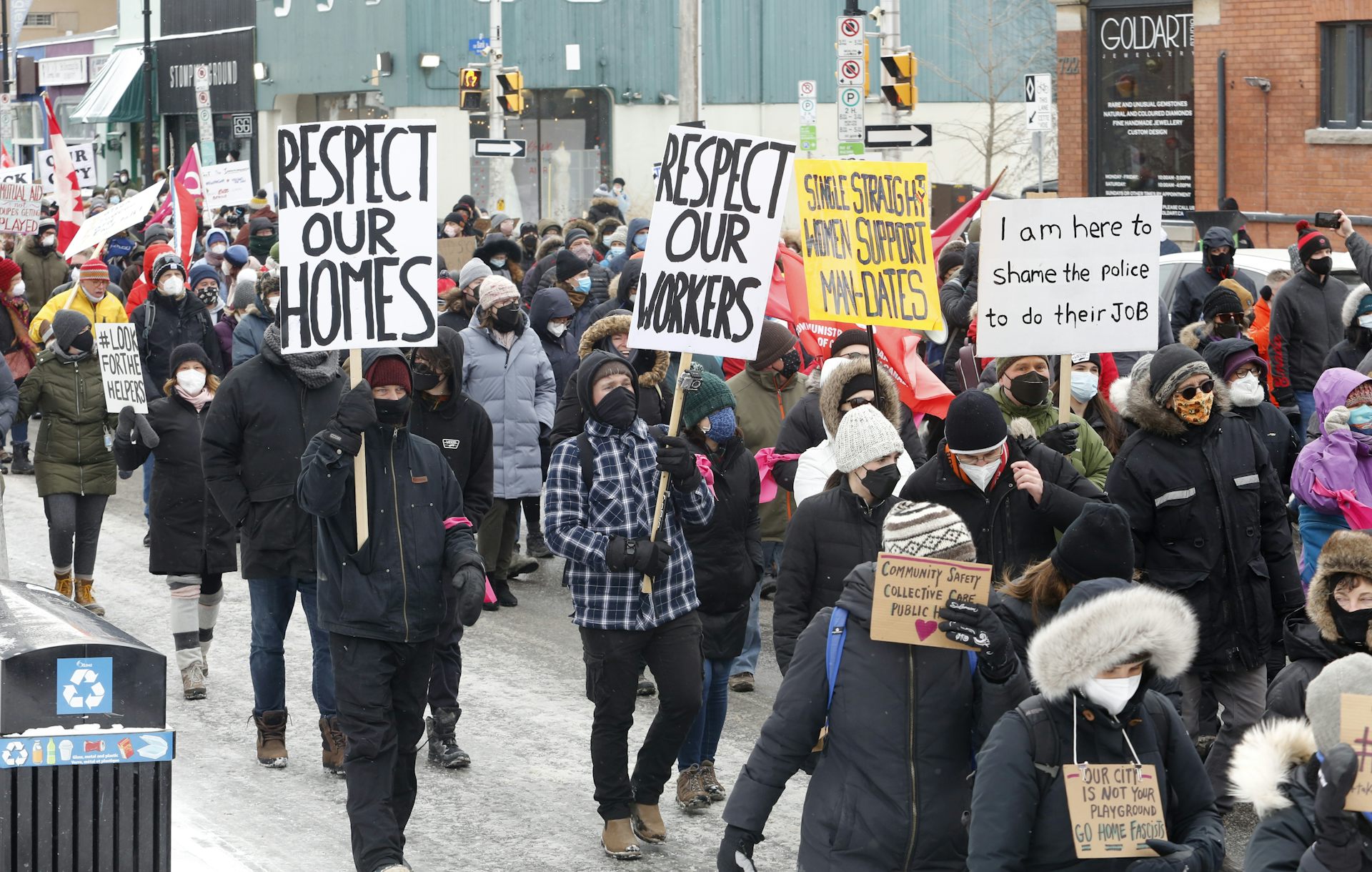 A group of people with placards seen in the street.