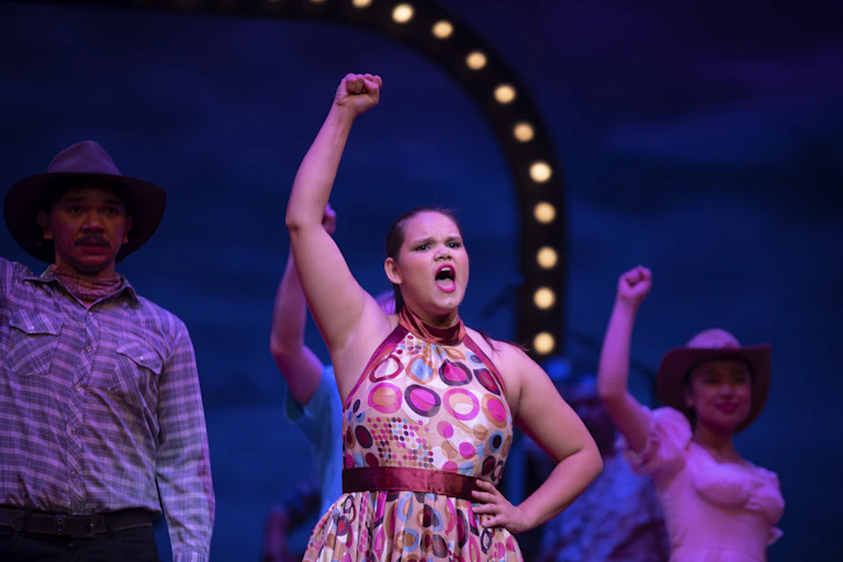 Production image - a woman with a raised fist