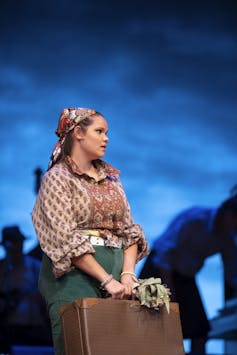 Production image: a woman with a suitcase