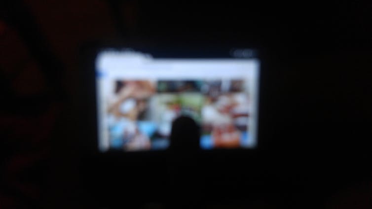 Blurred photo of person watching porn.