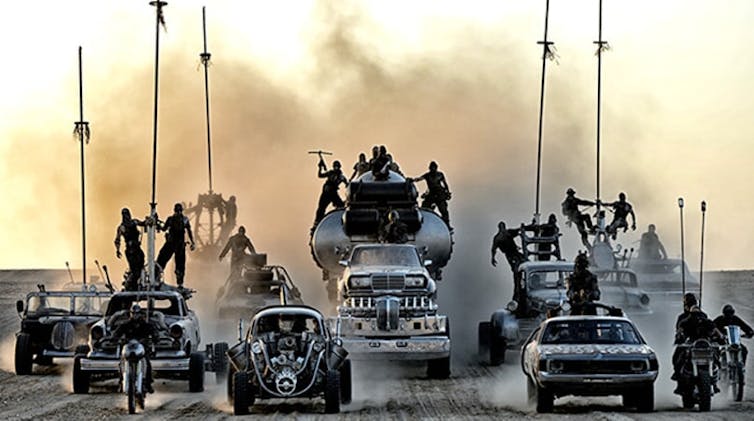 an image from the movie Mad Max Fury road showing a convoy of cars and trucks