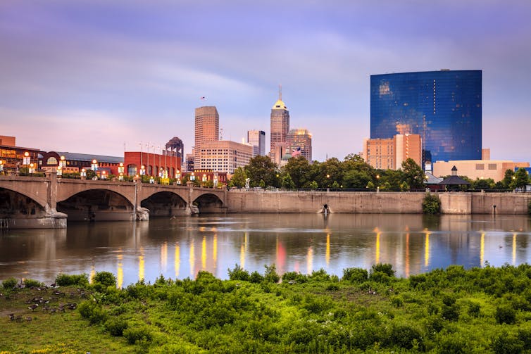 A view of the river with a bridge and the city in the background.