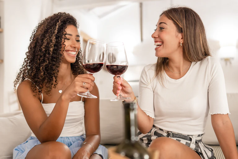 Two women drinking red wine