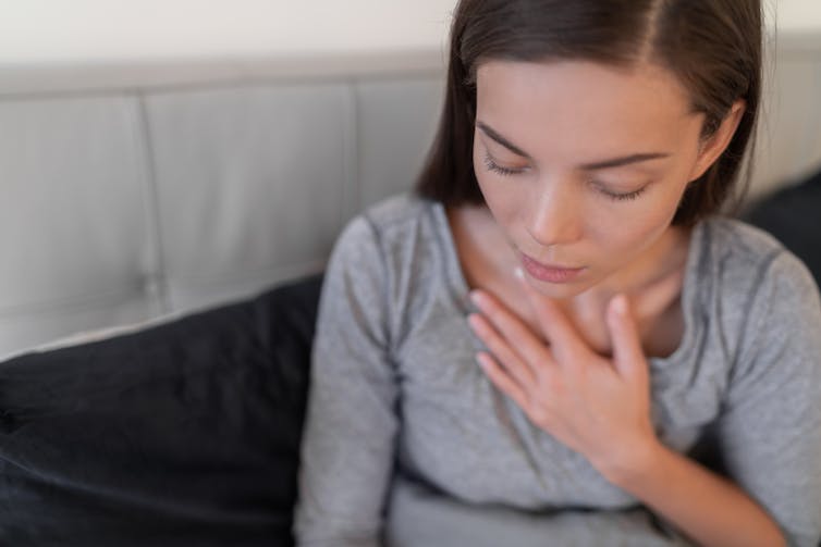 young girl looks short of breath in bed