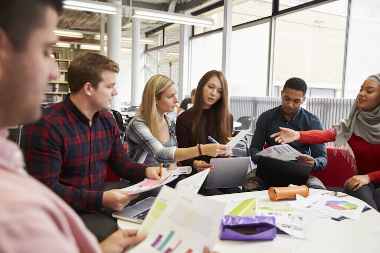 Group of university students working together around a table