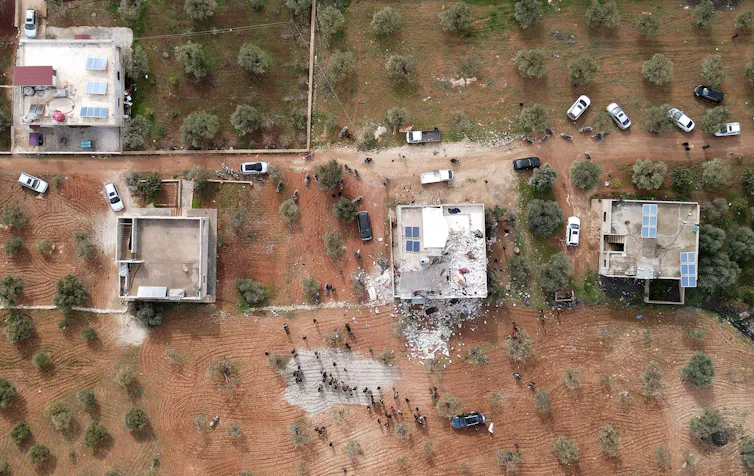 Aerial photograph of several buildings destroyed by a bombing raid in Syria.