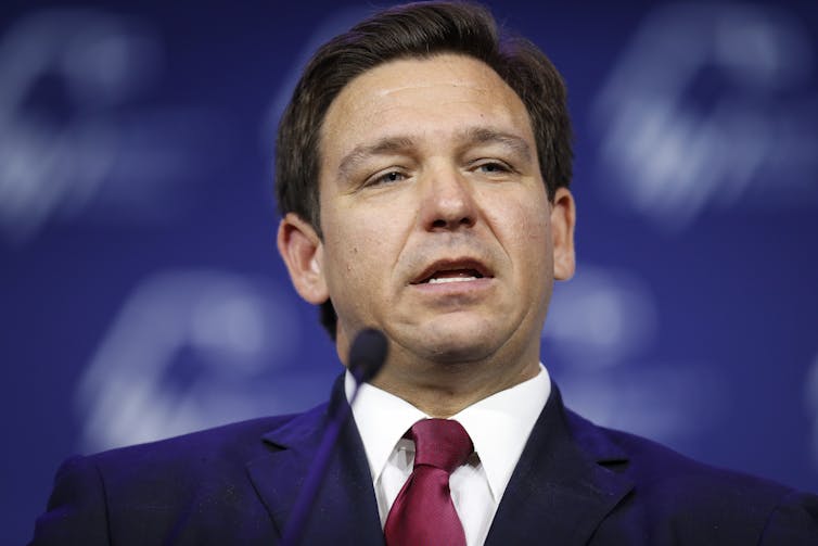 Close up photo of DeSantis speaking into a microphone