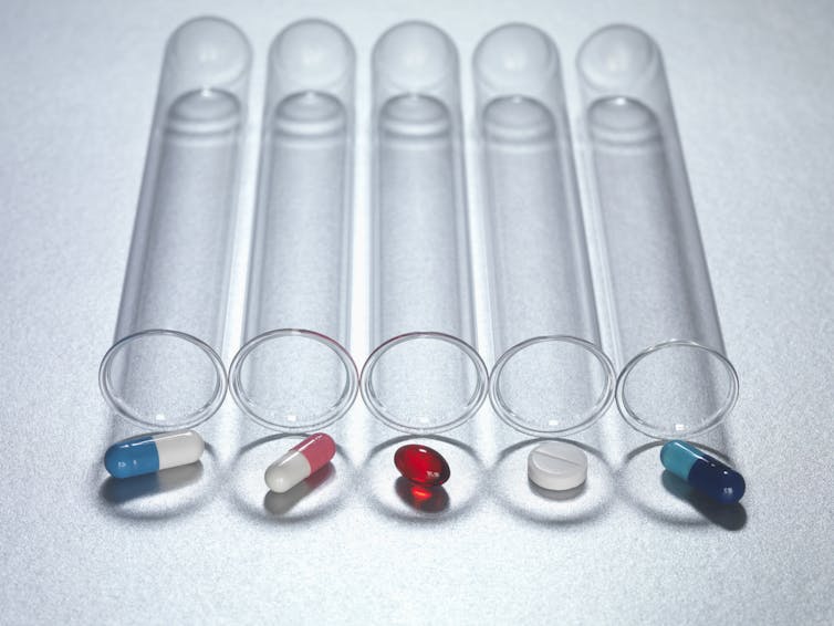 Medicine capsules in test tube