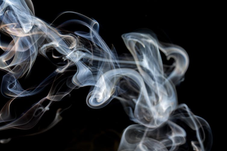 Curls of smoke against a black background.