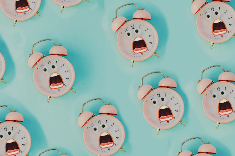 An illustration of grimacing cartoon "clock faces."