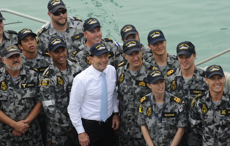 Abbott posing with patrol boat crew.
