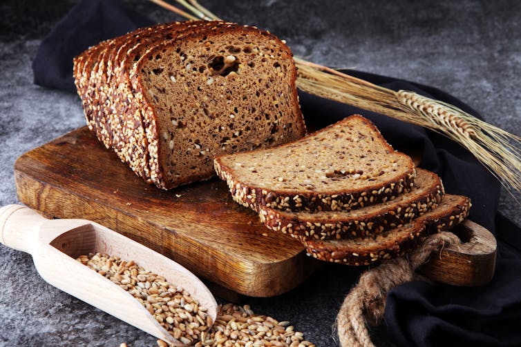 Sliced wholegrain rye bread with seeds on cutting board