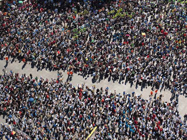 A crowd of people separated in the centre