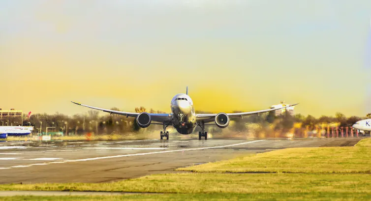 A commercial plane lands on a runway