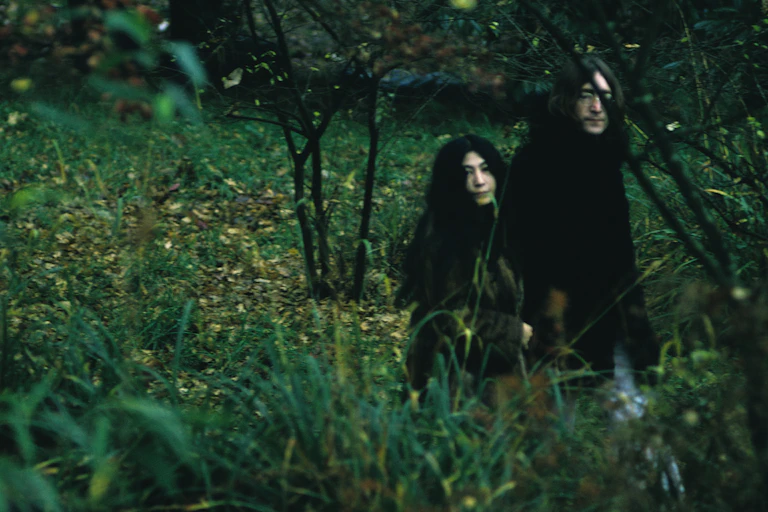 Man and woman in lush field.