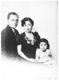 Black and white vintage photo of father, mother and child.
