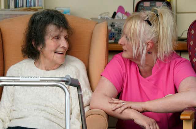 A carer and care home resident talking