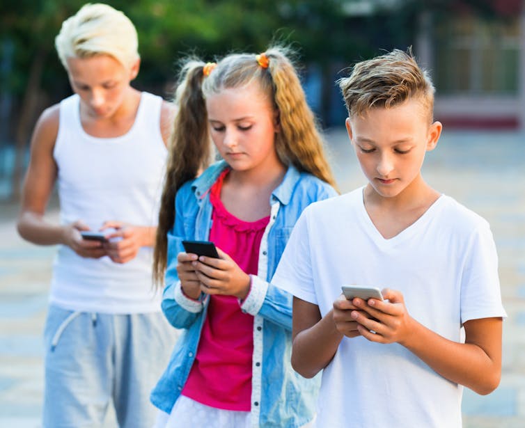 Young people looking at their mobile phones