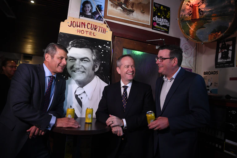 Bill Shorten, Daniel Andrews and Stev Bracks drinking a beer at the John Curtin Hotel