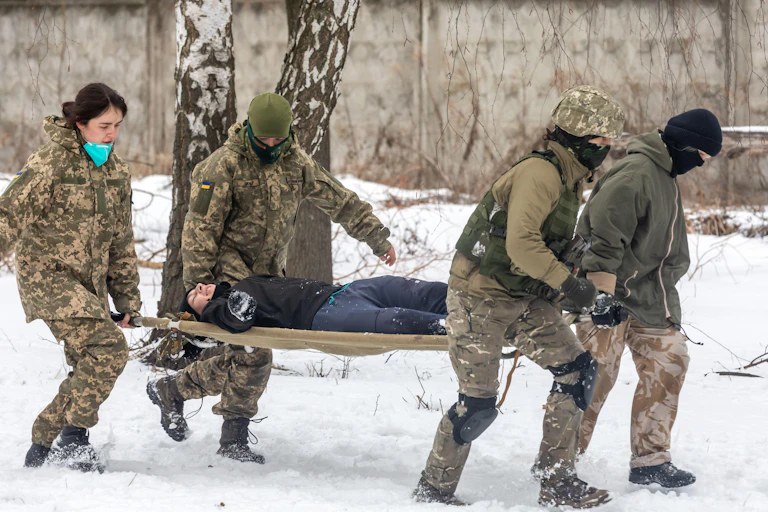 Four people carrying a stretcher.