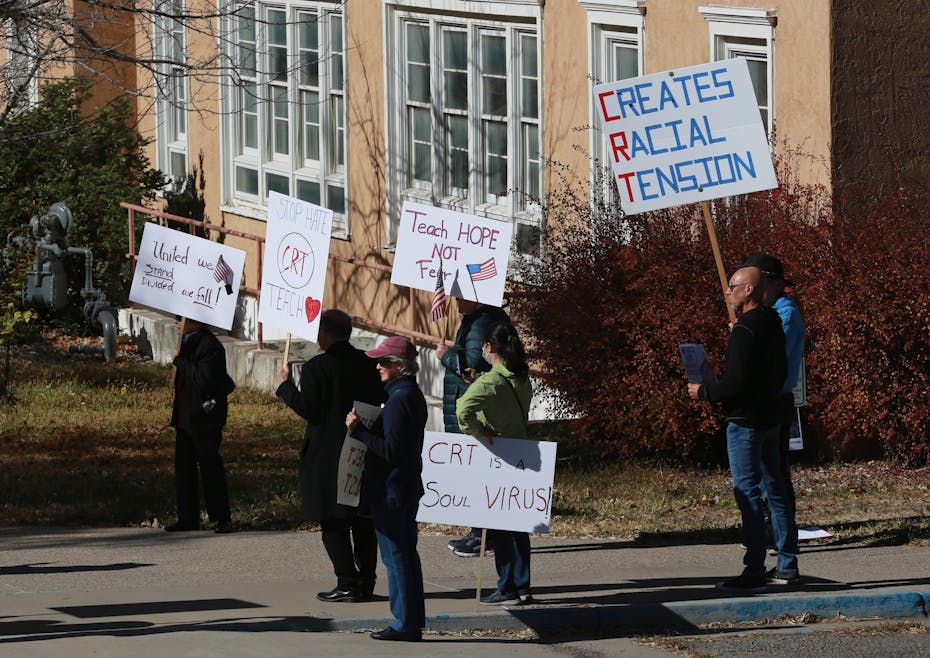 Protesters seen holding placards.