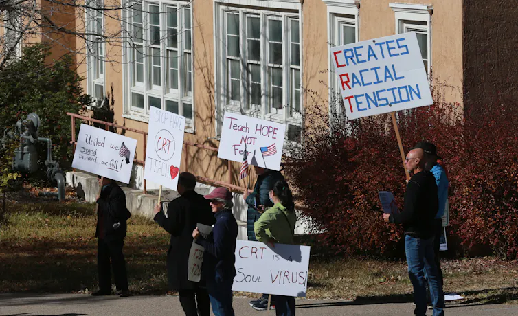 Protesters seen holding placards.
